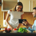 couple cooking with tablet in kitchen